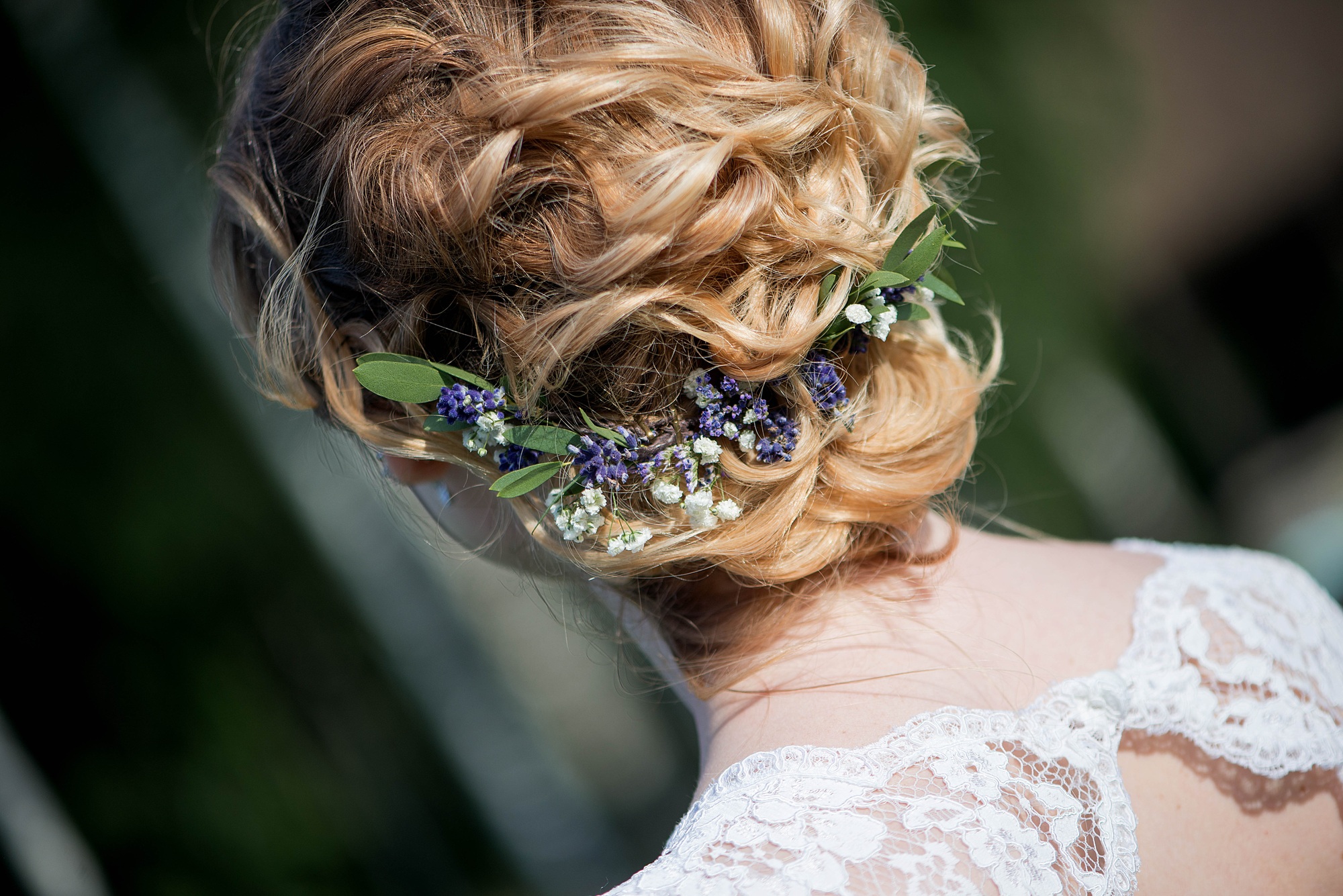 The bride is preparing for the wedding. Beautiful hairstyle with a hoop. Back of the head.